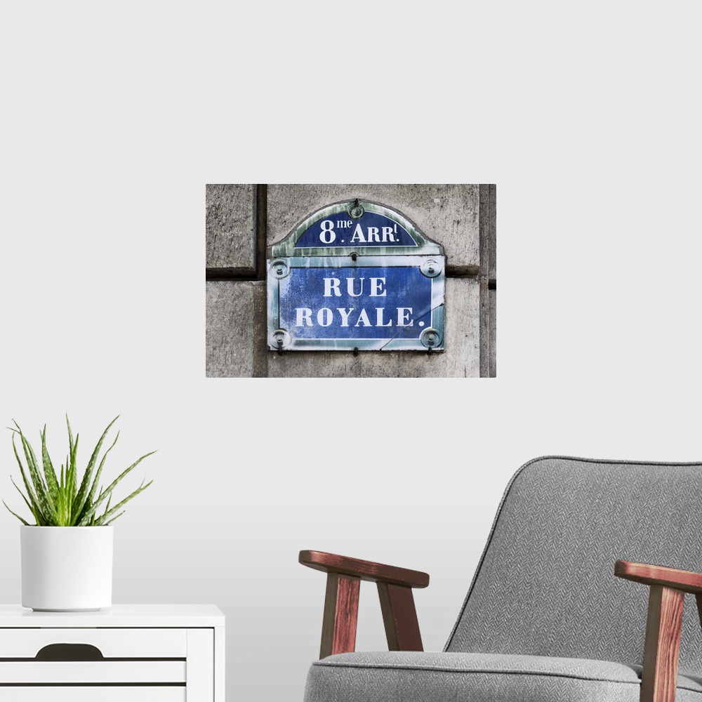 A modern room featuring Photograph of a Parisian sign against a stone wall.
