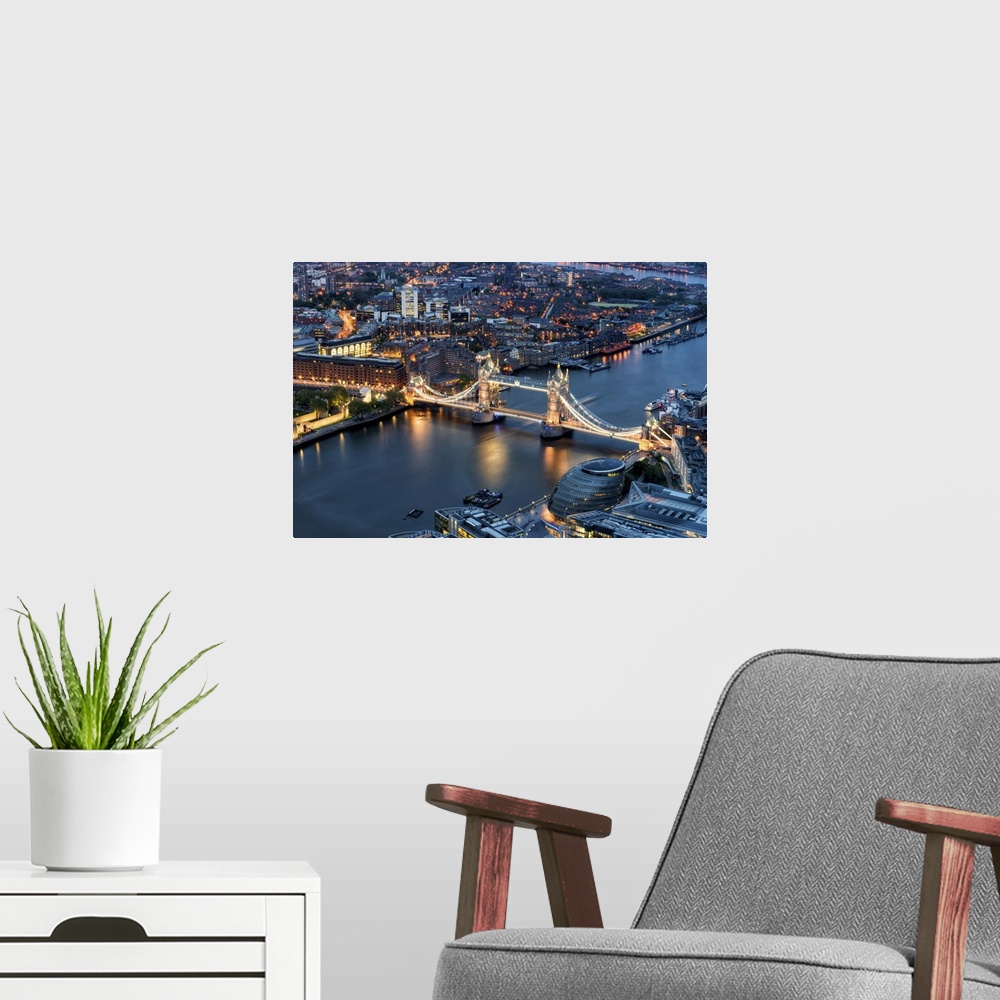 A modern room featuring Fine art photo of the River Thames and the Tower Bridge lit up in the evening.