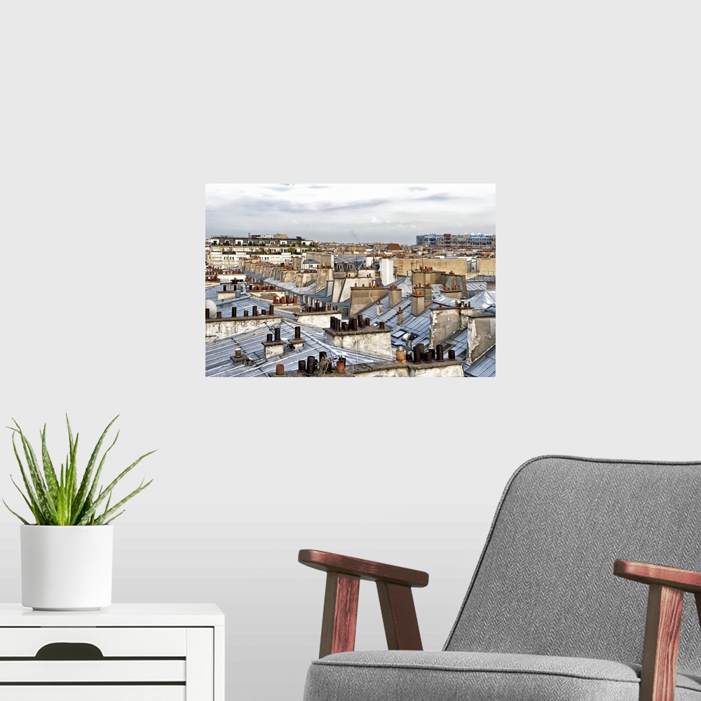 A modern room featuring Panoramic image of the windows and grey roofs of a row of Parisian buildings with the Paris skyli...