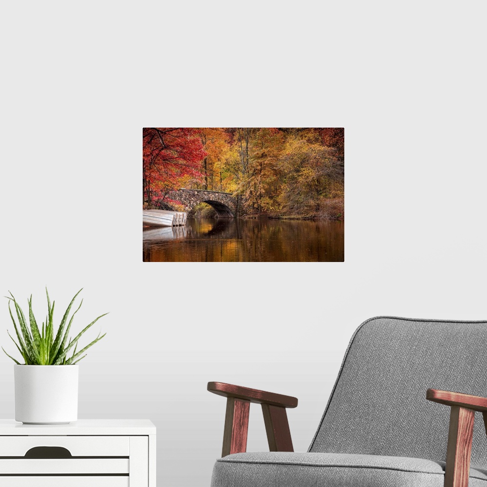 A modern room featuring Fall colors around a bridge and lake in Clove Lakes Park, Staten Island, New York.