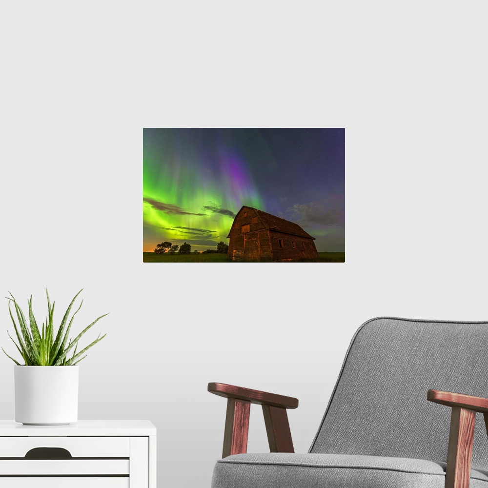 A modern room featuring Photograph of a barn with northern lights illuminating the sky at night.