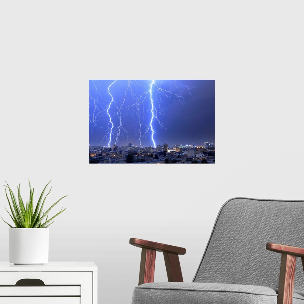 A modern room featuring Multiple exposures of lightning strikes over Bucharest, Romania.