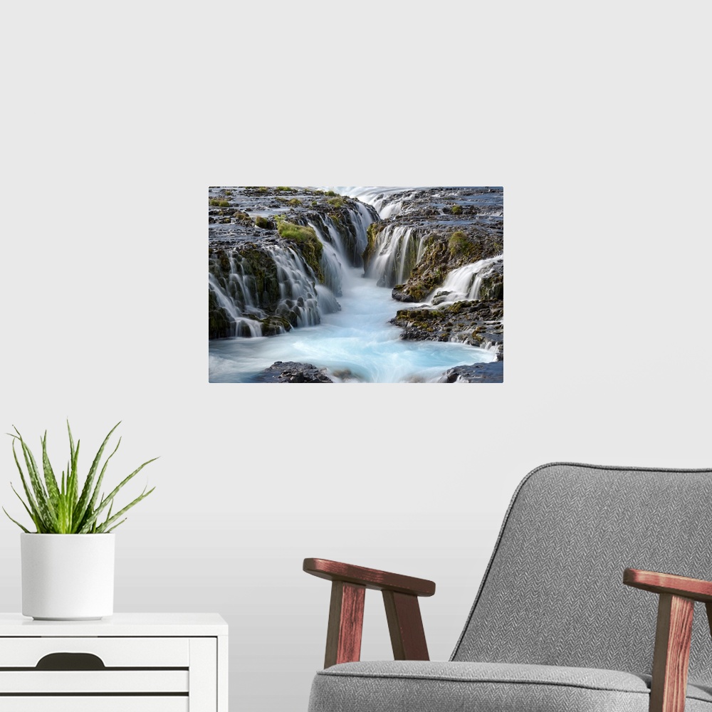 A modern room featuring Group of several waterfalls with glacial water in South Iceland.