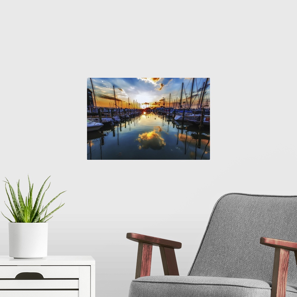 A modern room featuring Sailboats in a harbor casting perfect reflections in the water below.