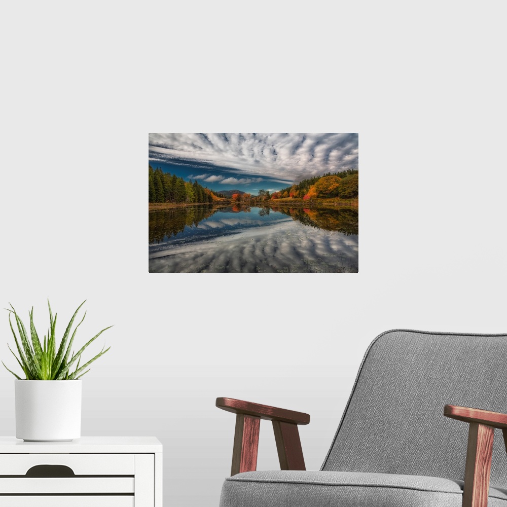 A modern room featuring Rippling clouds in the sky above Acadia National Park, mirrored in the lake below.