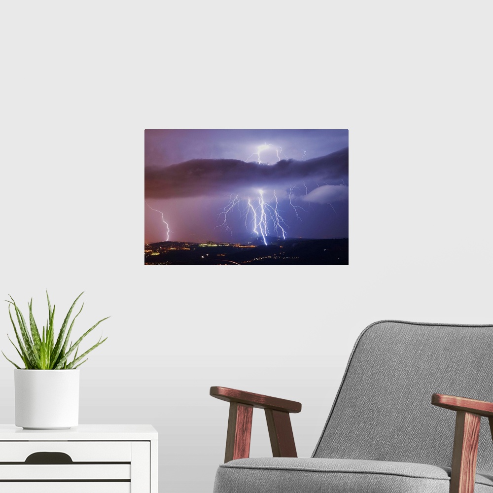 A modern room featuring This is a single exposure image of several consecutive lightning strikes into hills above Trieste...