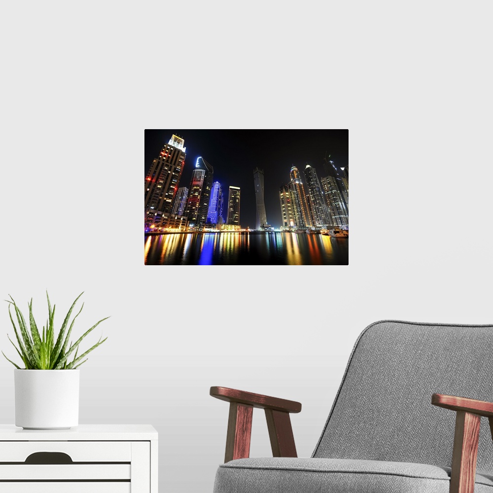 A modern room featuring Photograph of a dramatic view of a city skyline lit up in bright lights at night.