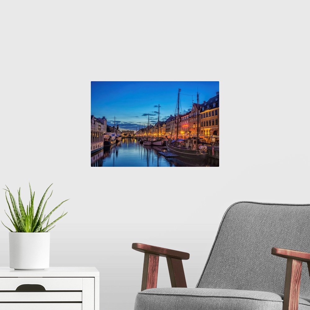A modern room featuring Waterfront with boats in the evening, Copenhagen, Denmark.