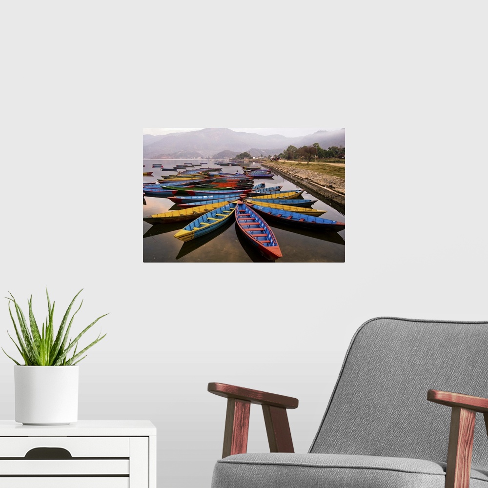 A modern room featuring Long tail boats in star formations in a misty harbor in Nepal.