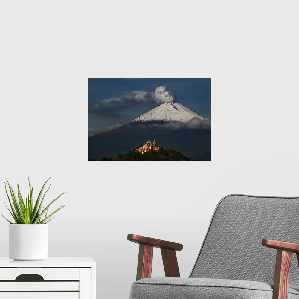 A modern room featuring Photograph of a volcano with smoke pluming out of the top.