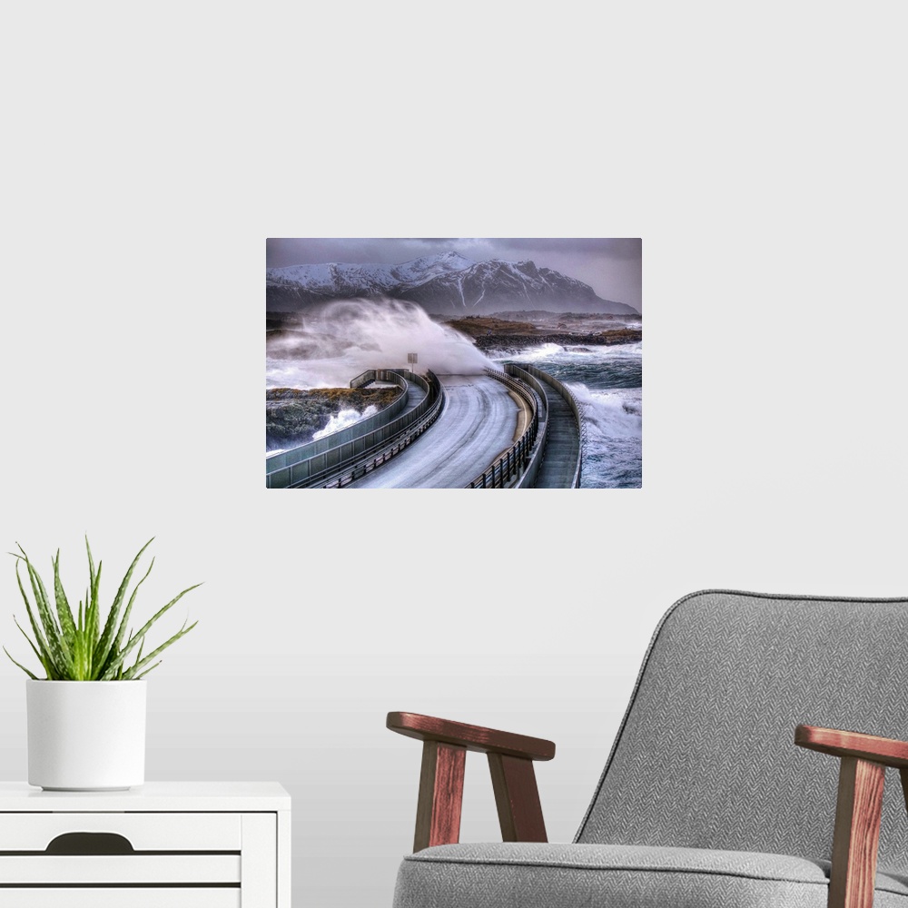 A modern room featuring Waves crashing over a road as a car speeds away from a coming storm, Norway.
