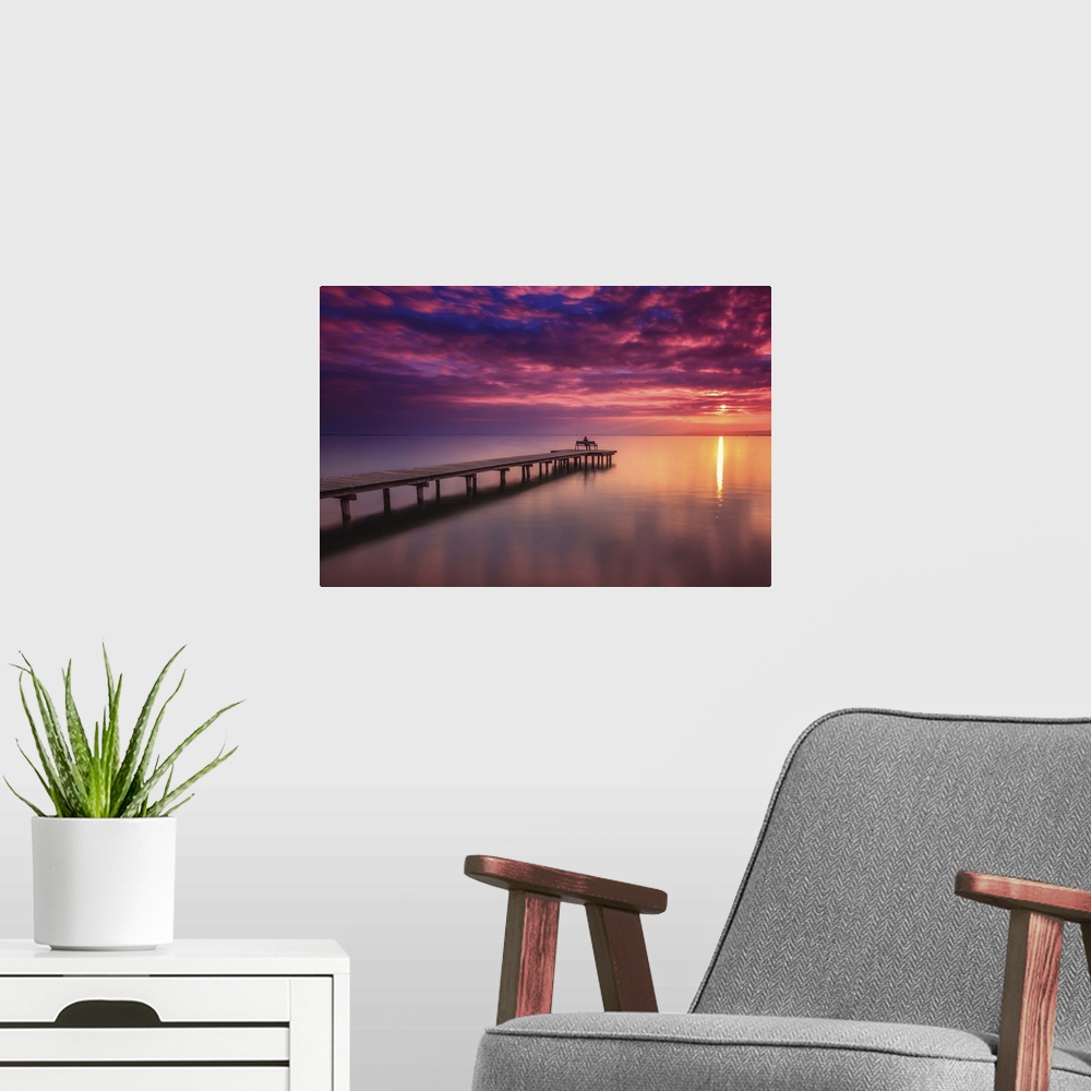 A modern room featuring A pier in Lake Neusiedl at sunset, Austria.