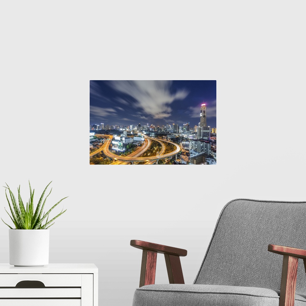A modern room featuring An aerial photograph of Thailand at night.