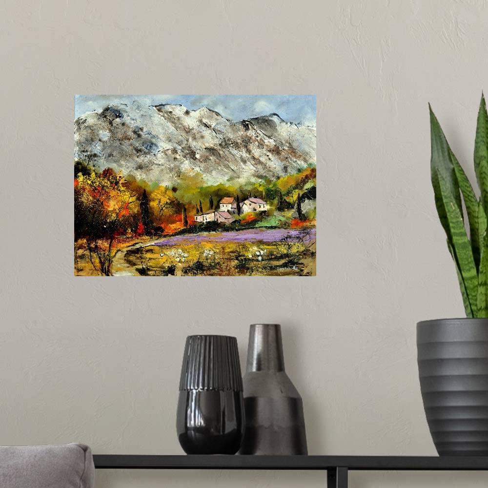 A modern room featuring A scenic landscape of houses along the valley of snow covered mountains.