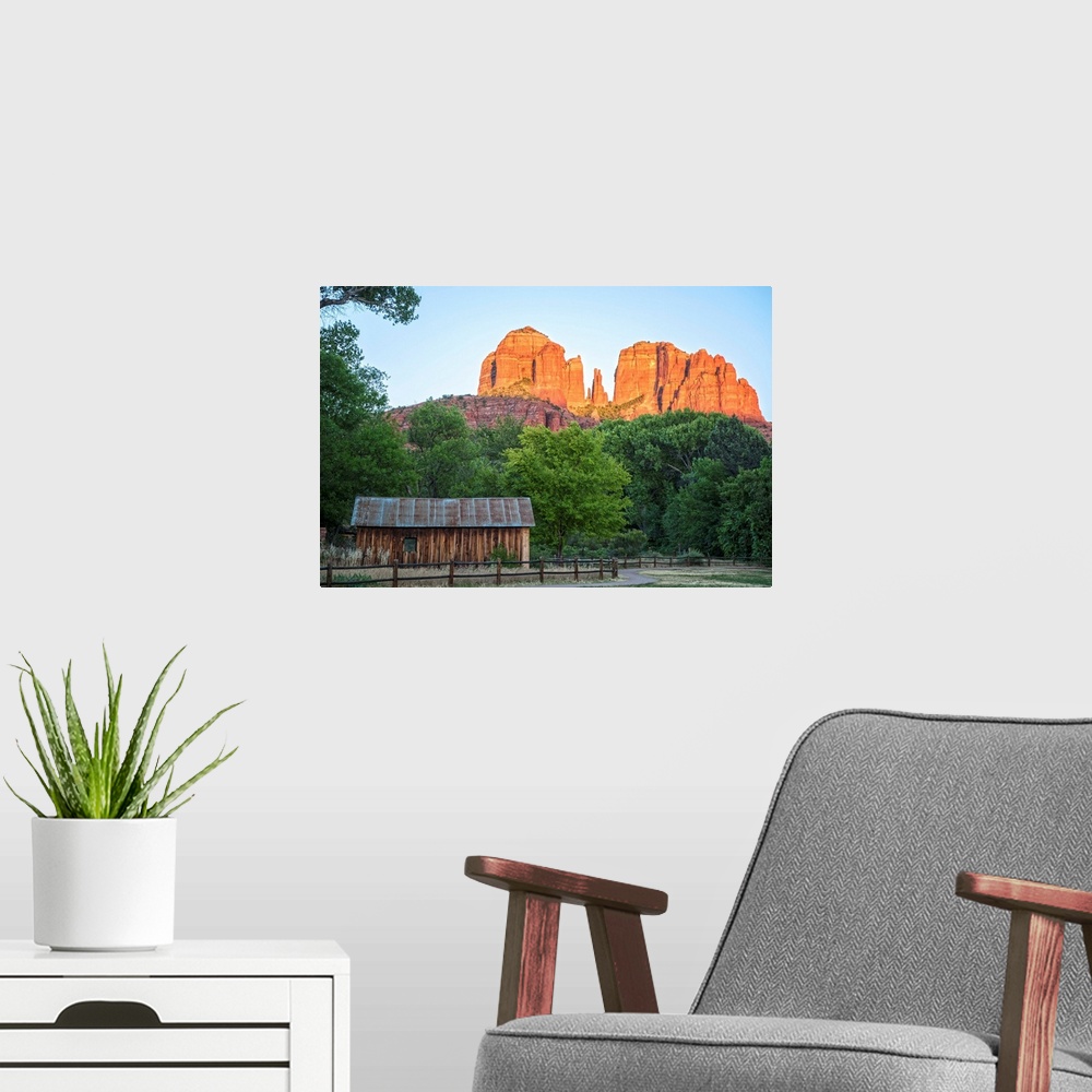 A modern room featuring Landscape photograph of Cathedral Rock with a rustic wooden structure in the foreground.
