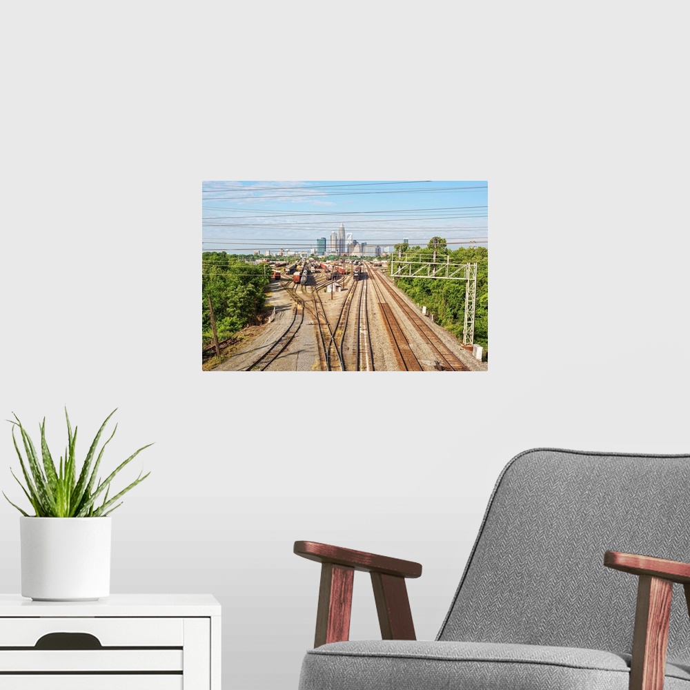 A modern room featuring A freight train leaving the city of Charlotte, North Carolina.