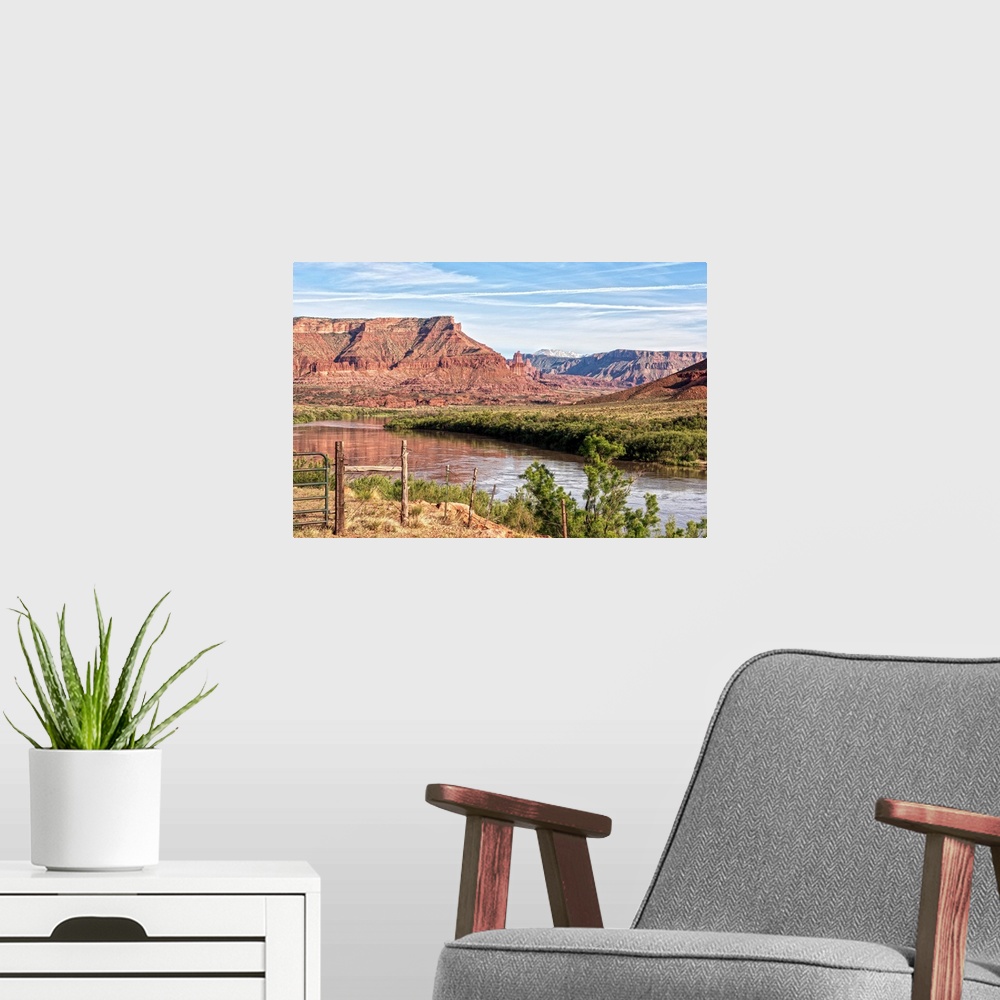 A modern room featuring The Colorado river running past the sandstone cliffs of the Red Rock Canyon, Arches National Park...