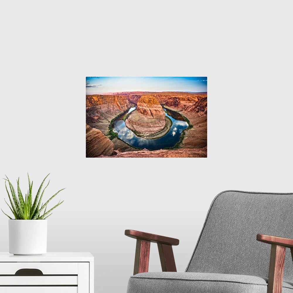 A modern room featuring Landscape photograph of Horseshoe Bend in Page, Arizona with blue cloudy skies reflecting into th...