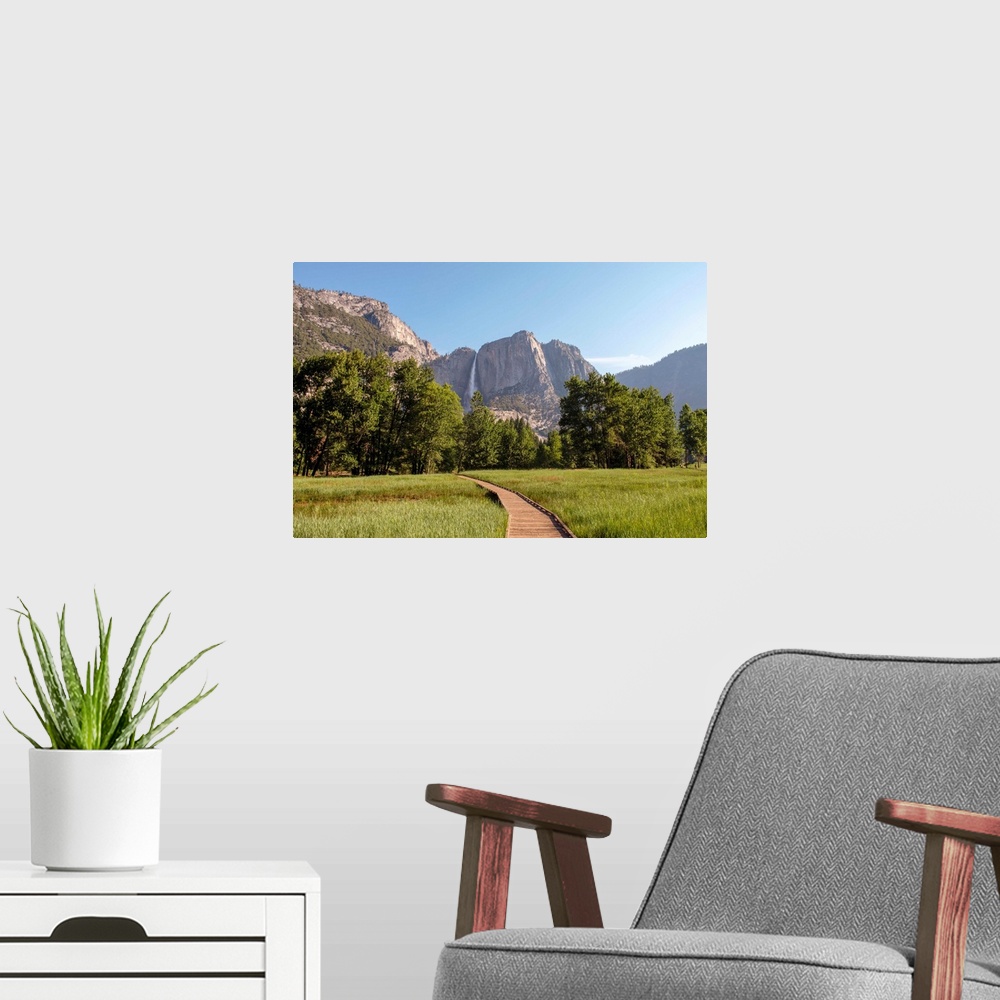 A modern room featuring View of wooden pathway with Yosemite Falls in the background, Yosemite National Park, California.