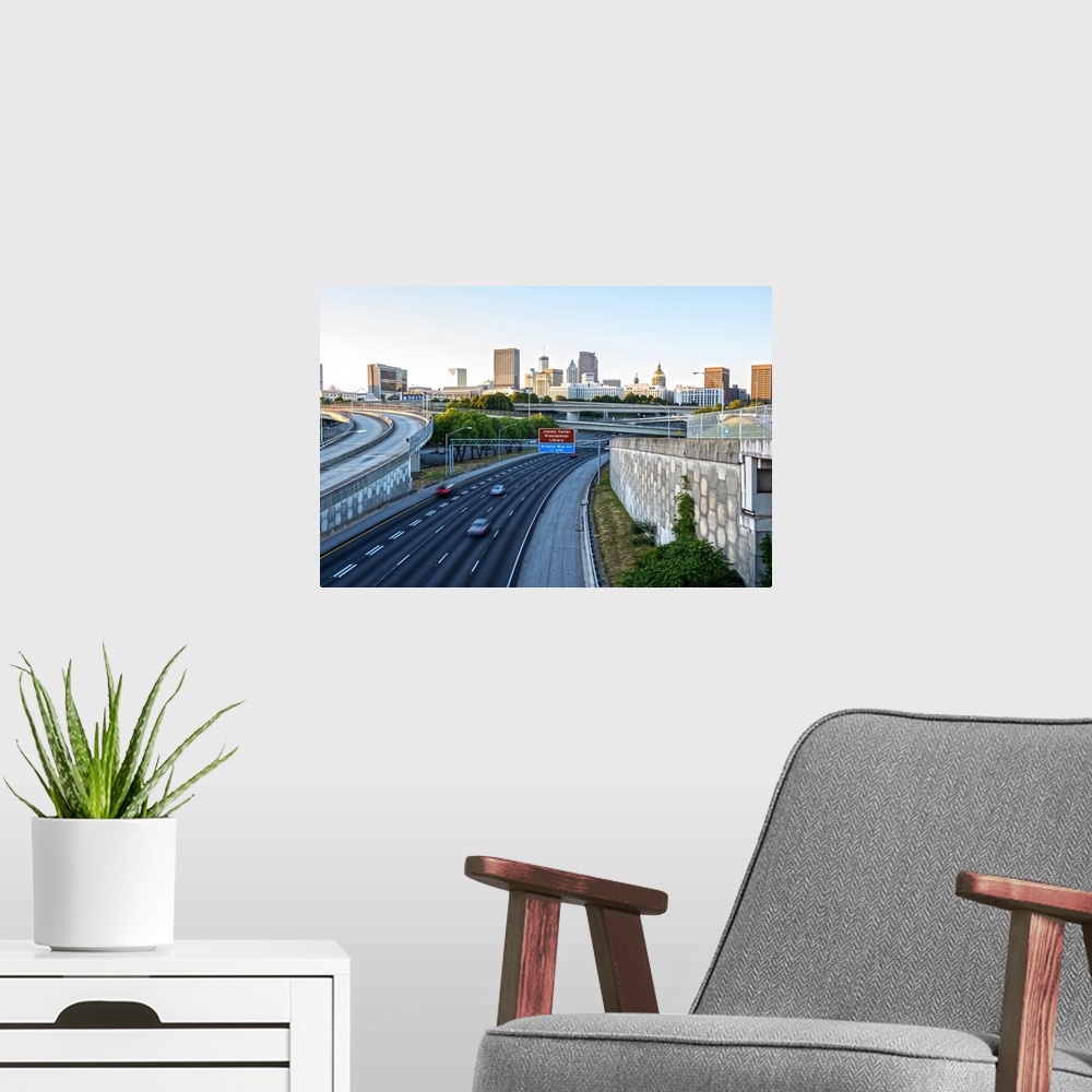 A modern room featuring Nearly empty freeway with the Atlanta, Georgia skyline in the distance, in the early morning.