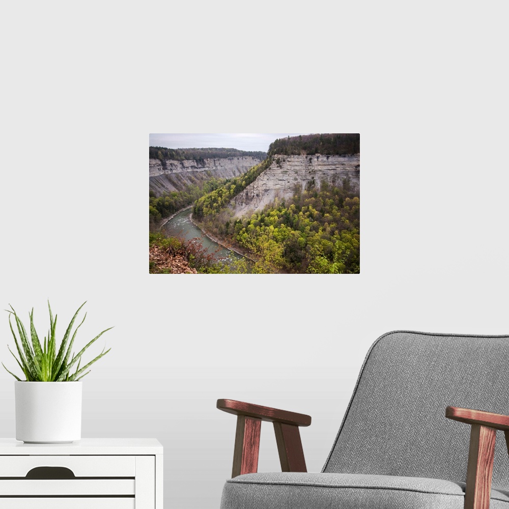 A modern room featuring Landscape photograph of the Genesee River bending around large rock formations at Letchworth Stat...