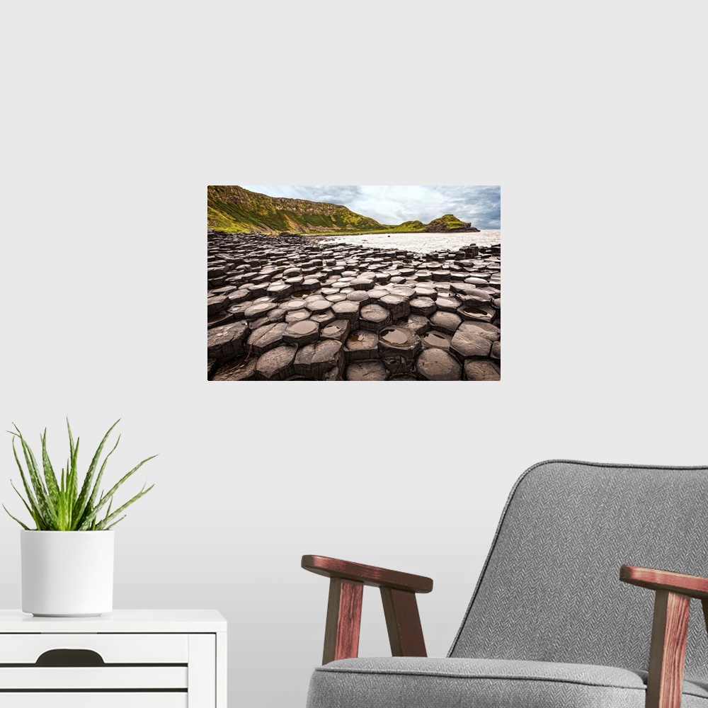 A modern room featuring Landscape photograph of the basalt columns on Giant's Causeway with rocky cliffs and the Atlantic...