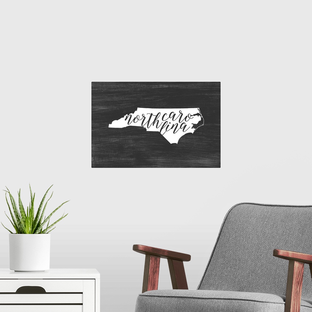 A modern room featuring North Carolina state outline typography artwork.
