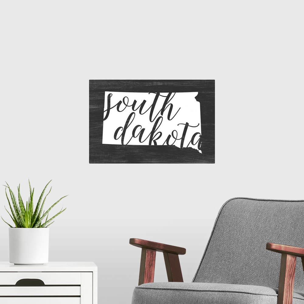 A modern room featuring South Dakota state outline typography artwork.