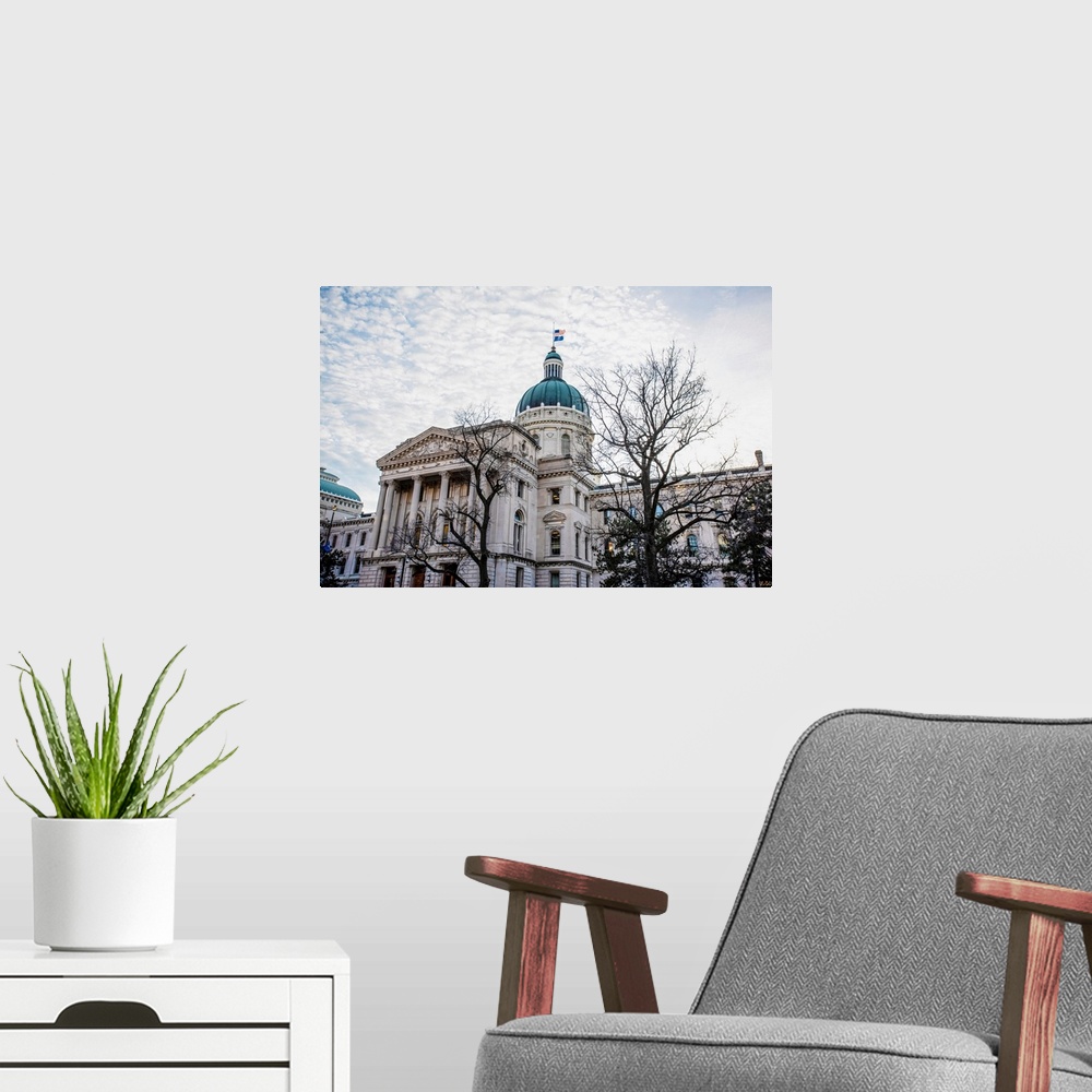 A modern room featuring Photo of the Indiana State House under puffy clouds.