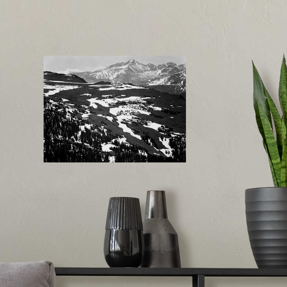 A modern room featuring Long's Peak, Rocky Mountain National Park, panorama of plateau, snow covered mountain in background.