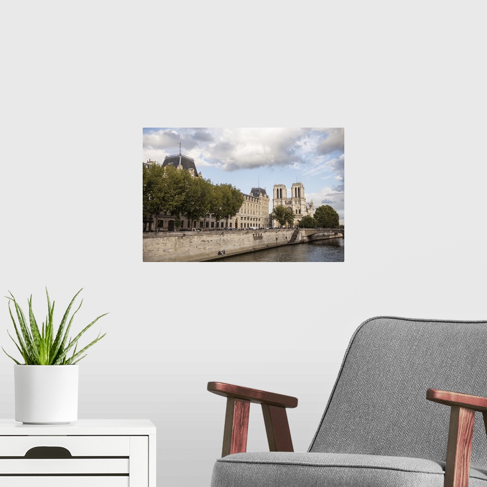 A modern room featuring Photograph of the Notre Dame gothic architecture from the water.