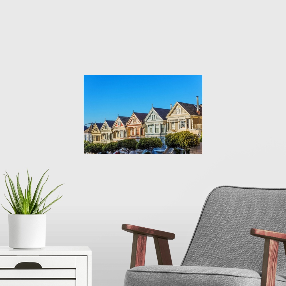 A modern room featuring Photograph of the Painted Ladies in downtown San Francisco with a bright blue sky above.