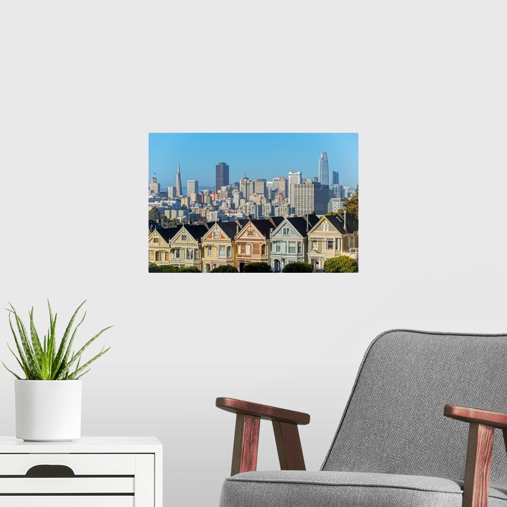A modern room featuring Photograph of the Painted Ladies in downtown San Francisco with tall buildings in the background.