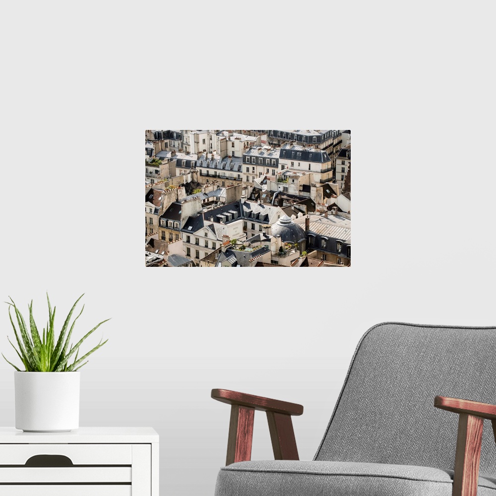 A modern room featuring Aerial photograph of roof tops in Paris, France