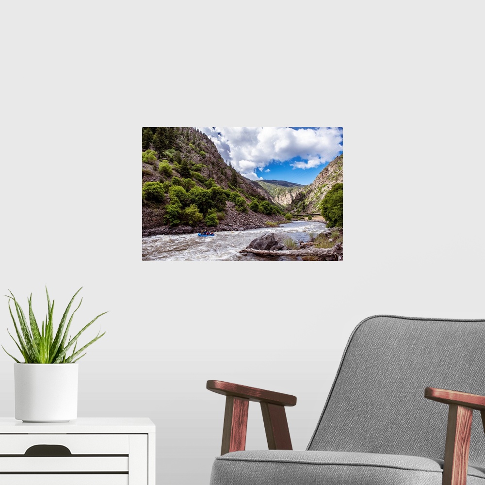 A modern room featuring Photo of a rushing river under a mountain cliffside in Colorado.