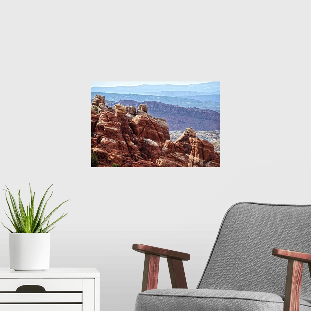 A modern room featuring Sandstone formations in the Fiery Furnace, overlooking the Salt Valley with the La Sal mountains ...