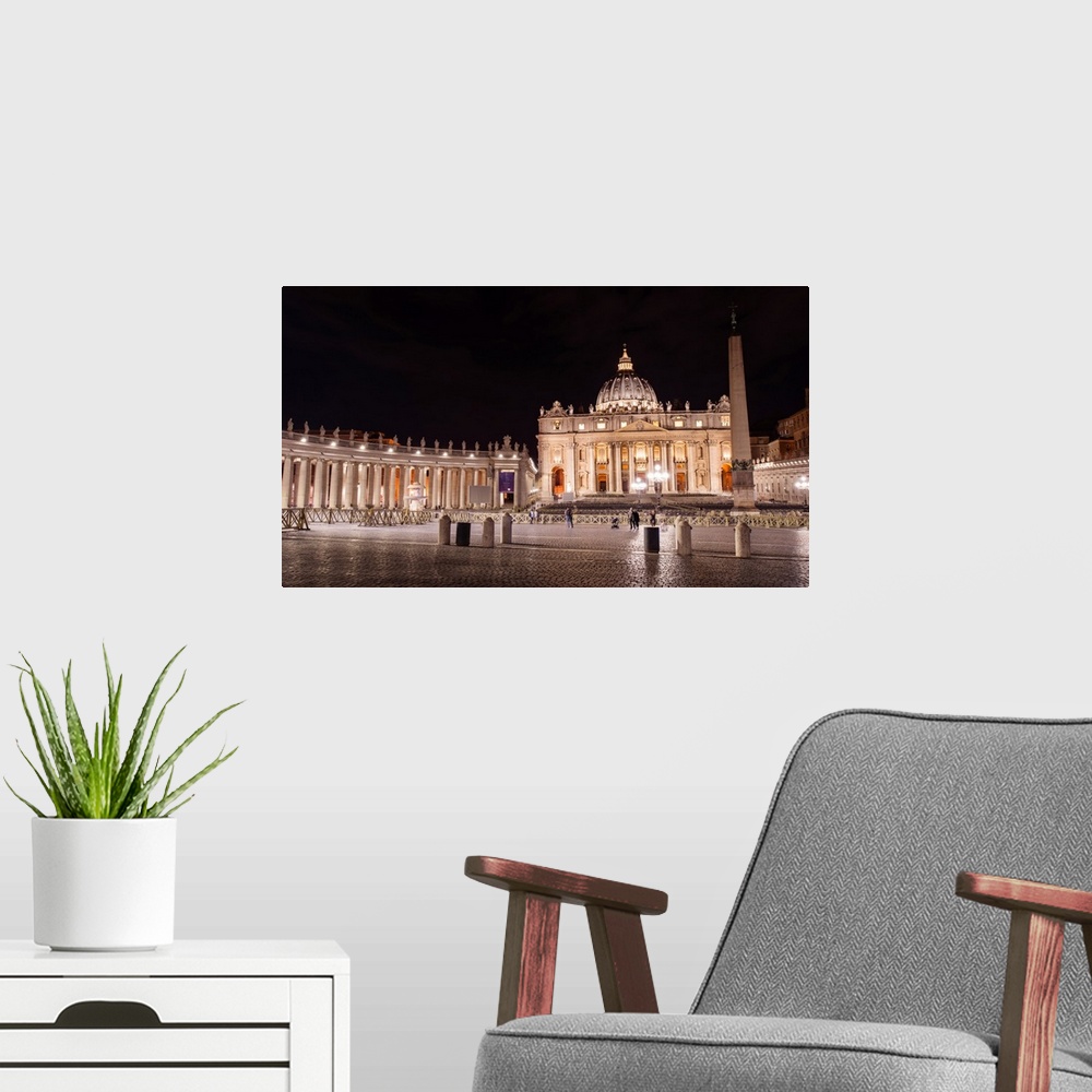 A modern room featuring Photograph of St. Peter's Basilica at St. Peter's Square in Vatican City at night.