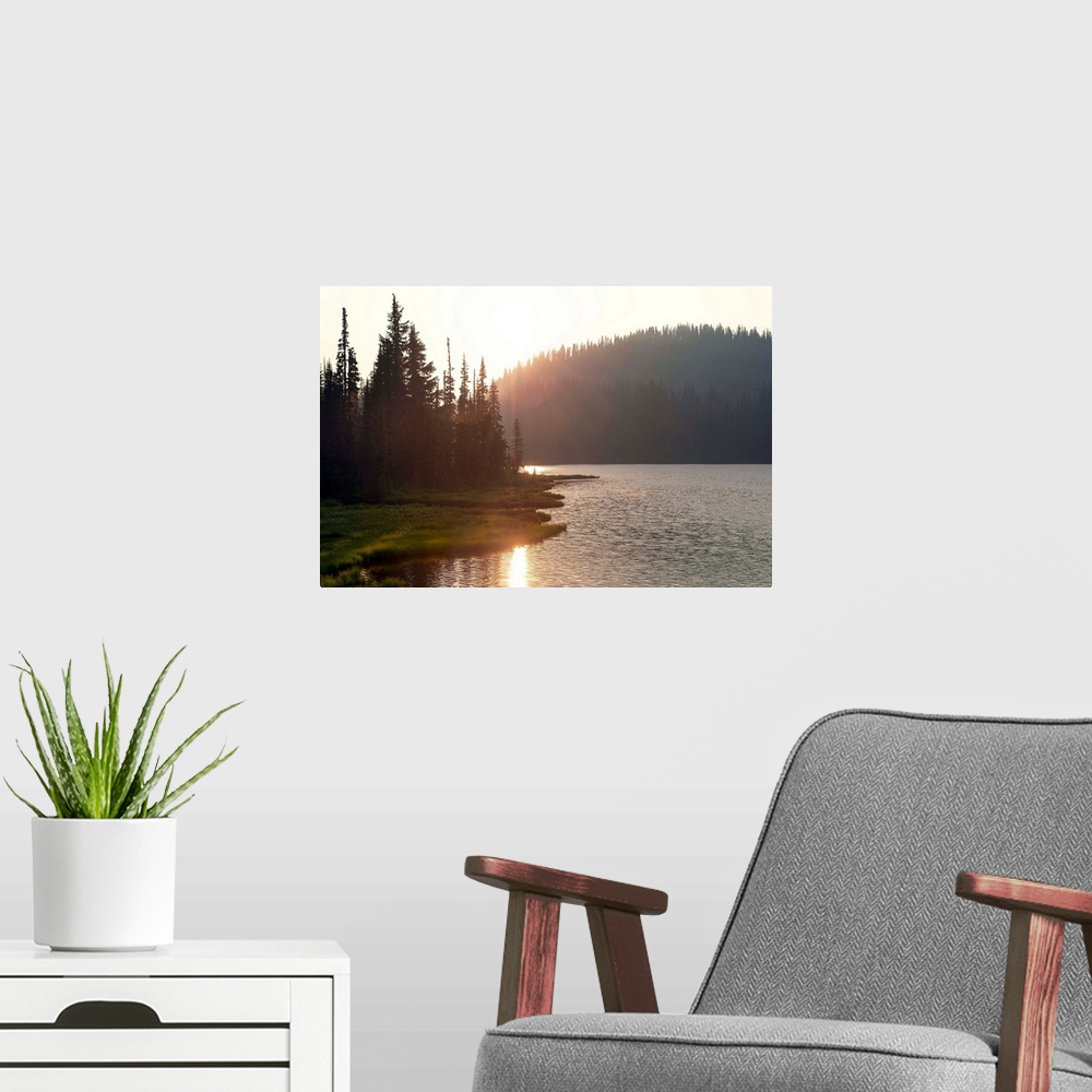 A modern room featuring The sun sets on a lake in Mount Rainier National Park, Washington.