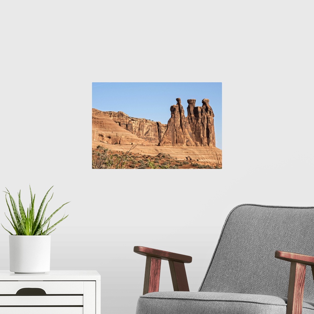 A modern room featuring The Three Gossips, sandstone formation in the Courthouse Towers area of Arches National Park, Moa...