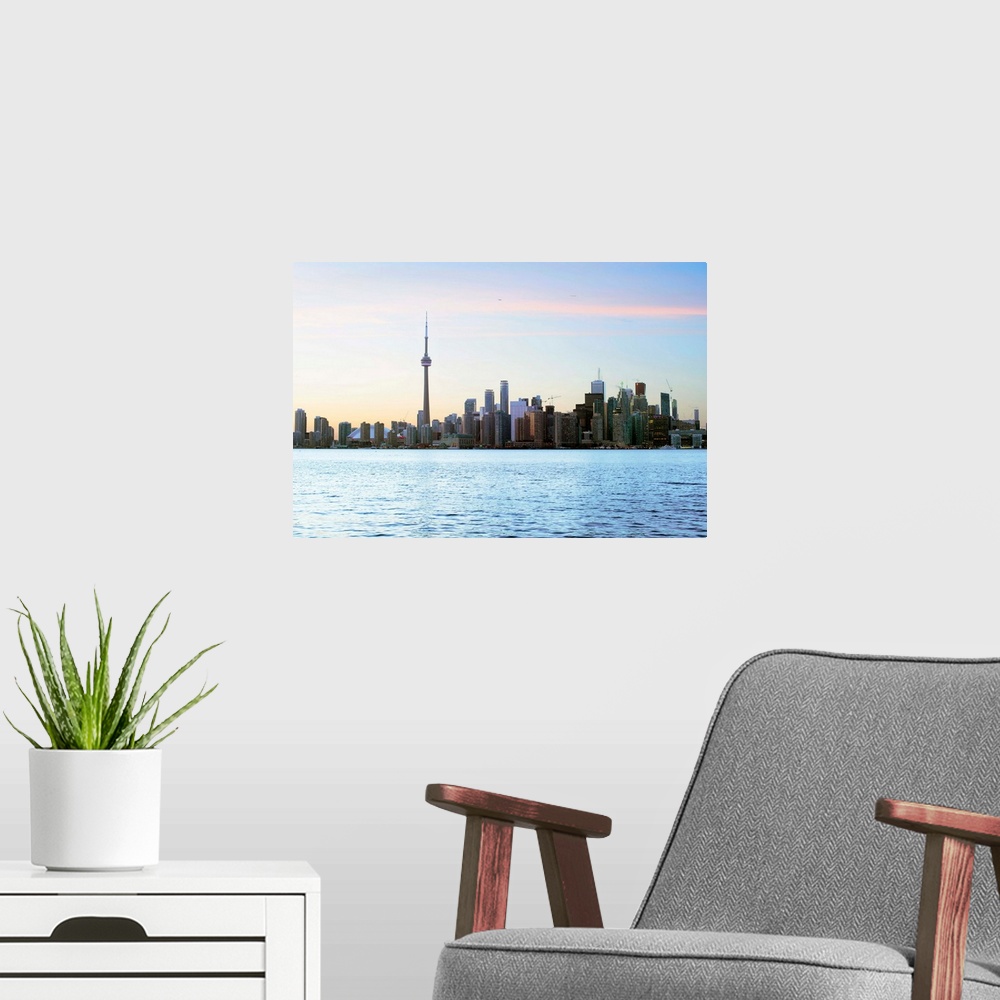 A modern room featuring Toronto city skyline with Lake Ontario in the foreground.