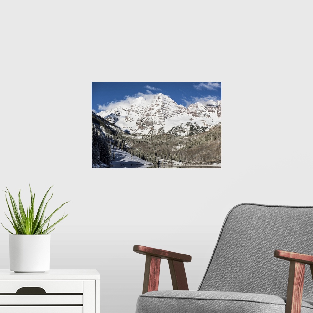 A modern room featuring Wind-blown snow on the peaks of the Maroon Bells under a blue sky in Aspen, Colorado.