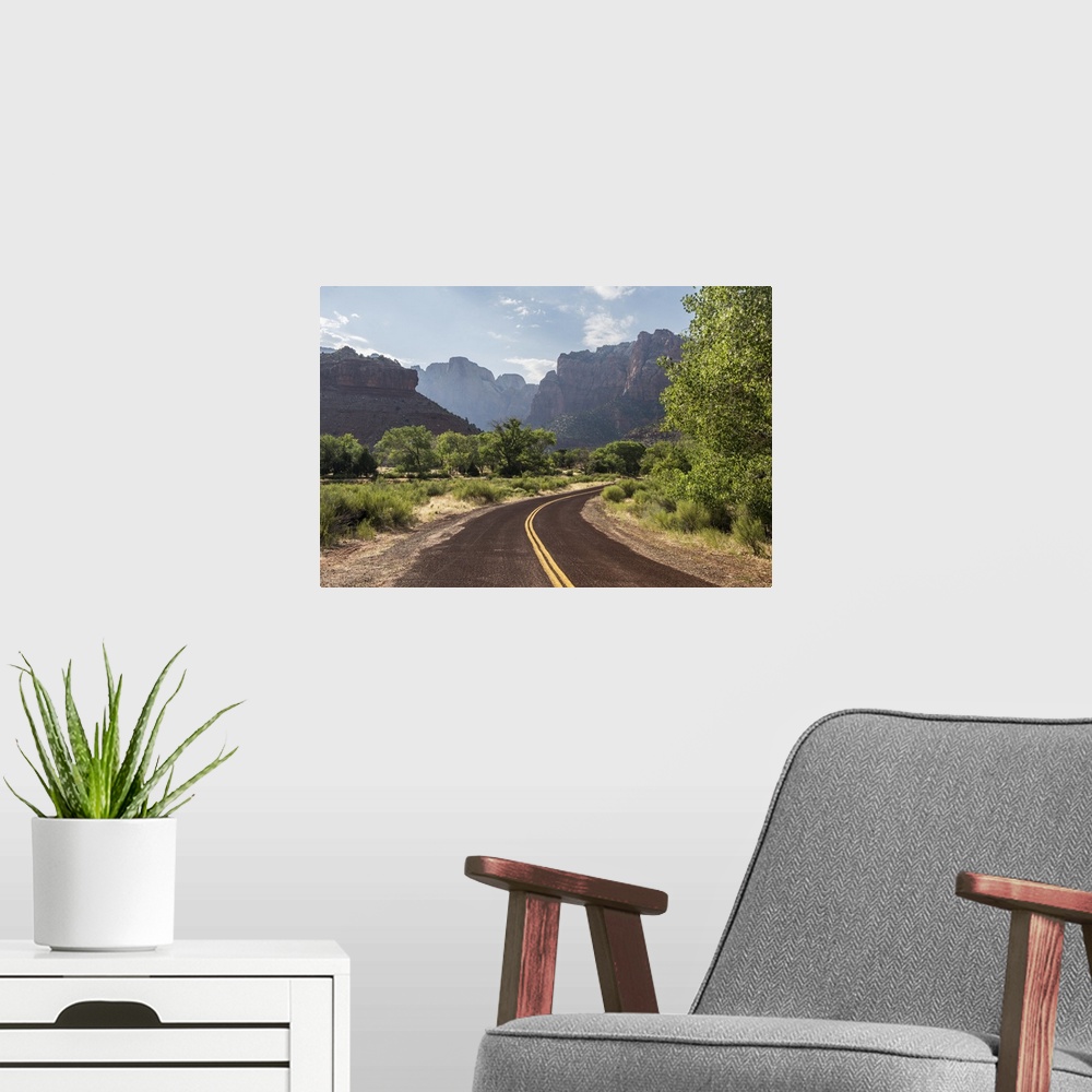 A modern room featuring View of Zion National Parks large red canyons from a winding road.