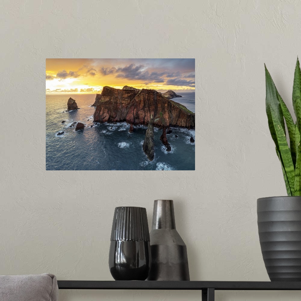 A modern room featuring Burning sky at dawn on cliffs washed by ocean, Ponta do Rosto viewpoint, Sao Lourenco Peninsula, ...