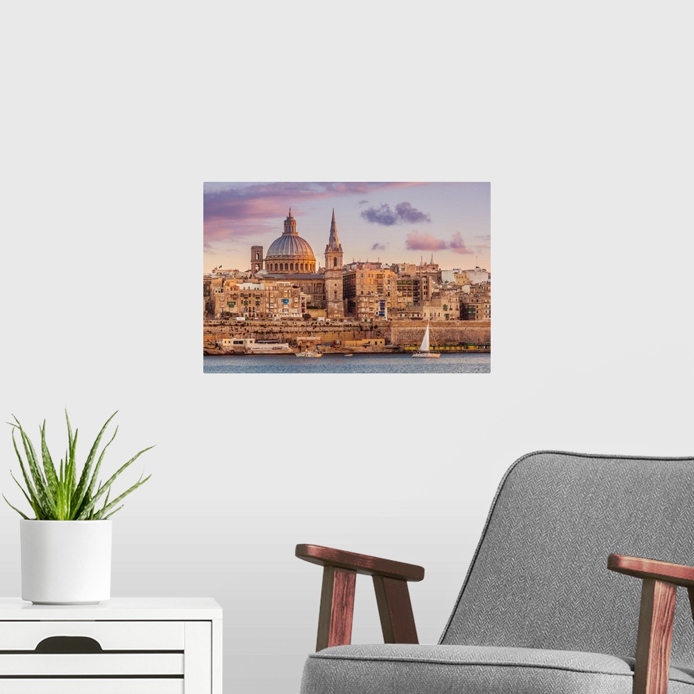 A modern room featuring Valletta skyline at sunset with the Carmelite Church dome and St. Pauls Anglican Cathedral, Valle...