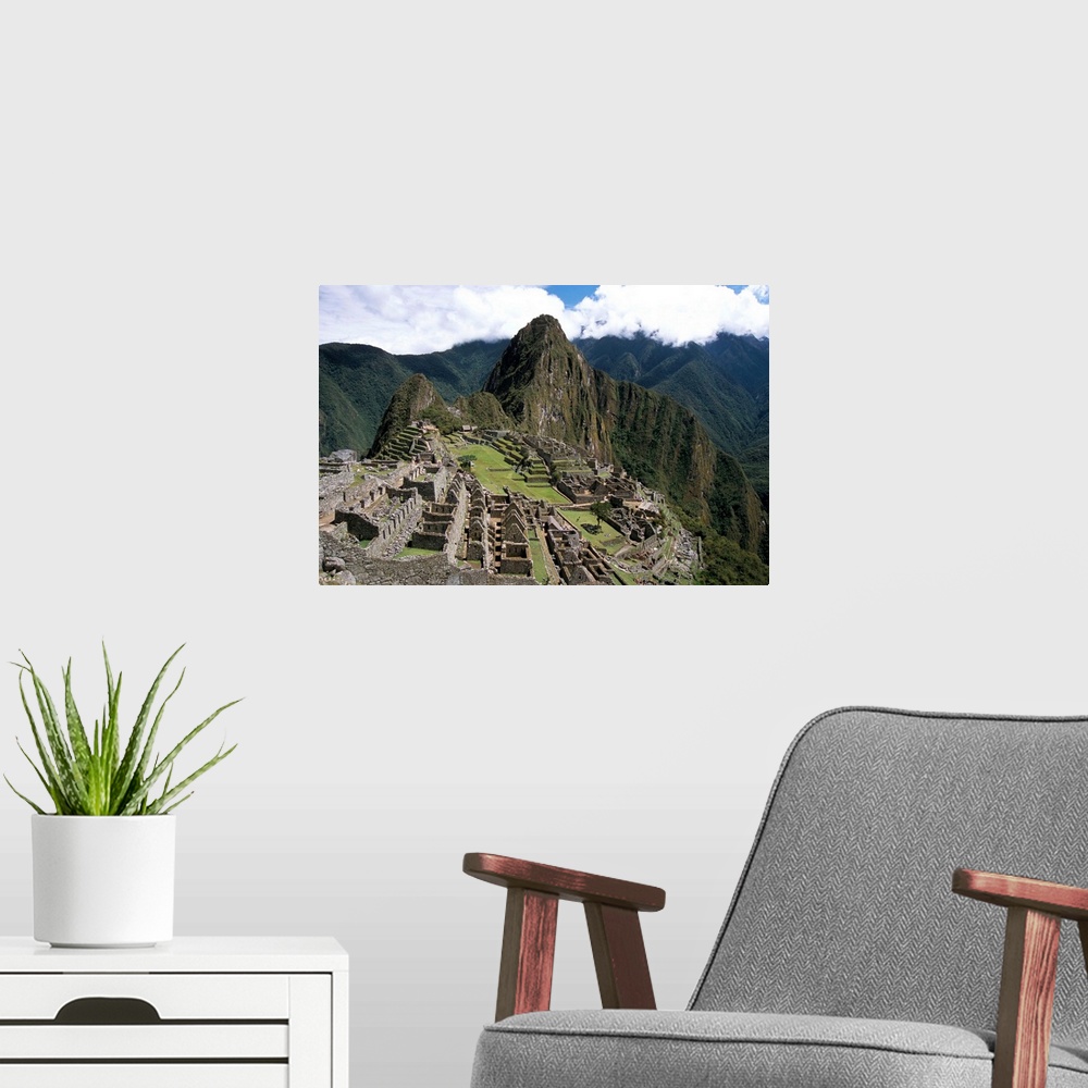 A modern room featuring Classic view from Funerary Rock of Inca town site, Machu Picchu, Peru