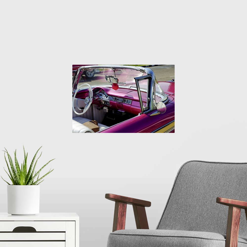 A modern room featuring Close view of driver's seat of classic vintage convertable car, Havana, Cuba, West Indies, Centra...