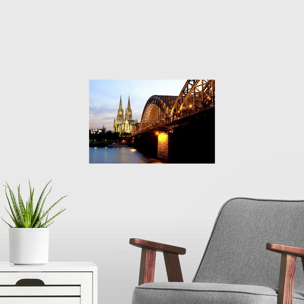 A modern room featuring Cologne cathedral and Hohenzollern bridge at night, Cologne, Germany