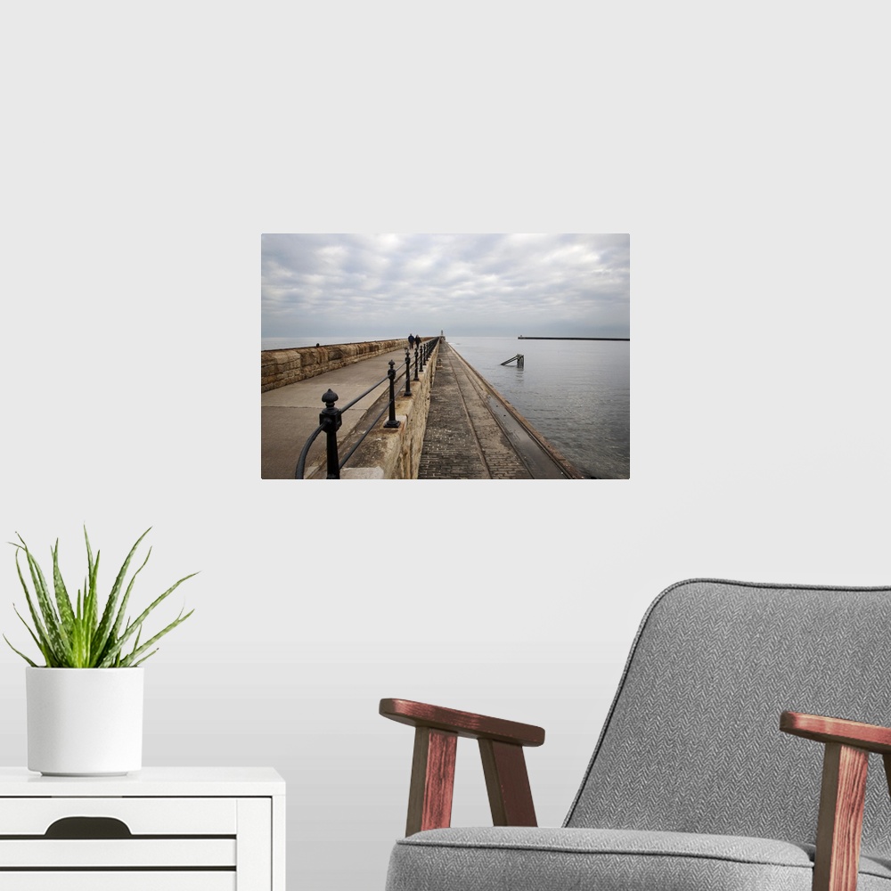 A modern room featuring Couple walking on the North Pier at Tynemouth, North Tyneside, Tyne and Wear, England