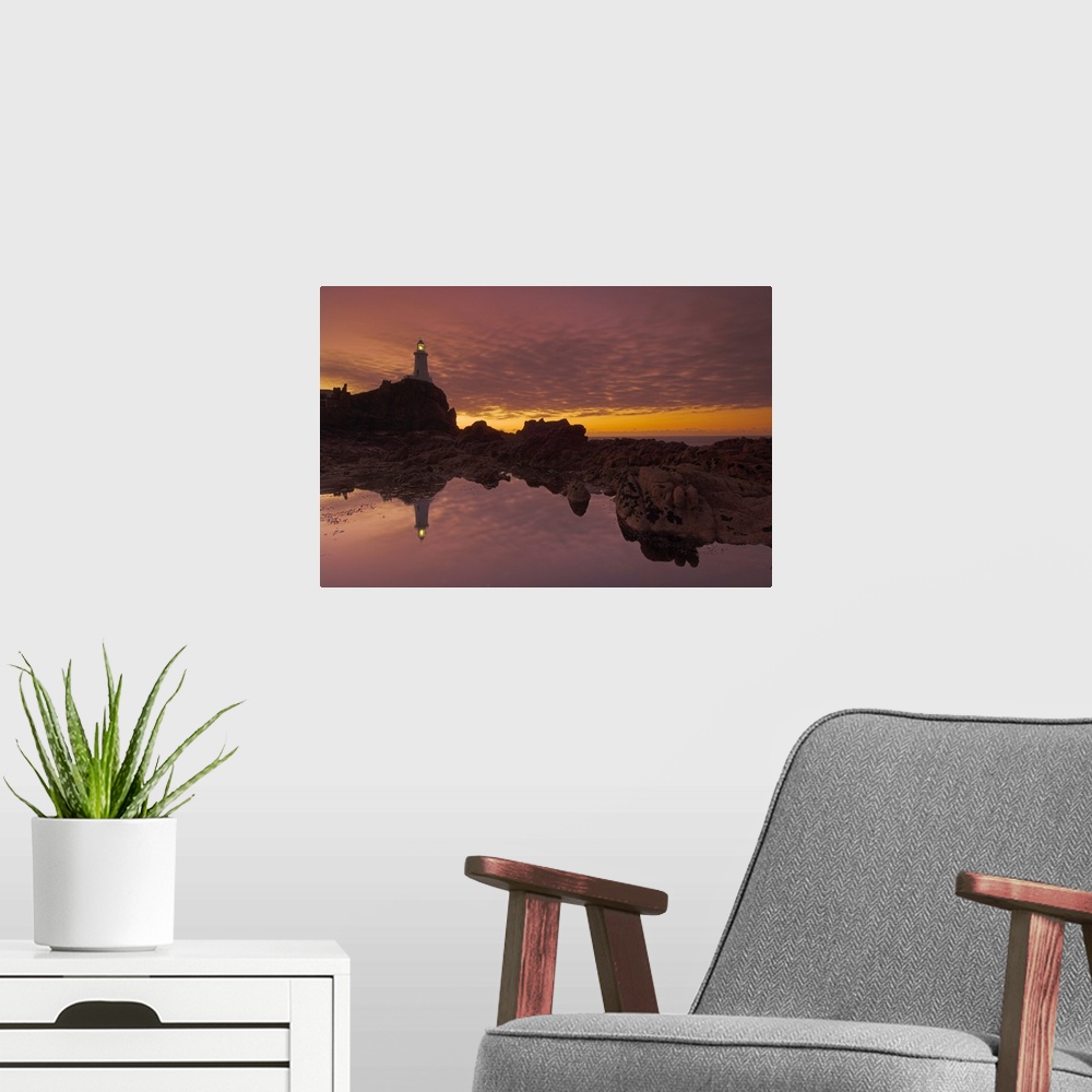 A modern room featuring Dramatic sunset and low tide, Corbiere lighthouse, St. Ouens, Jersey, Channel Islands