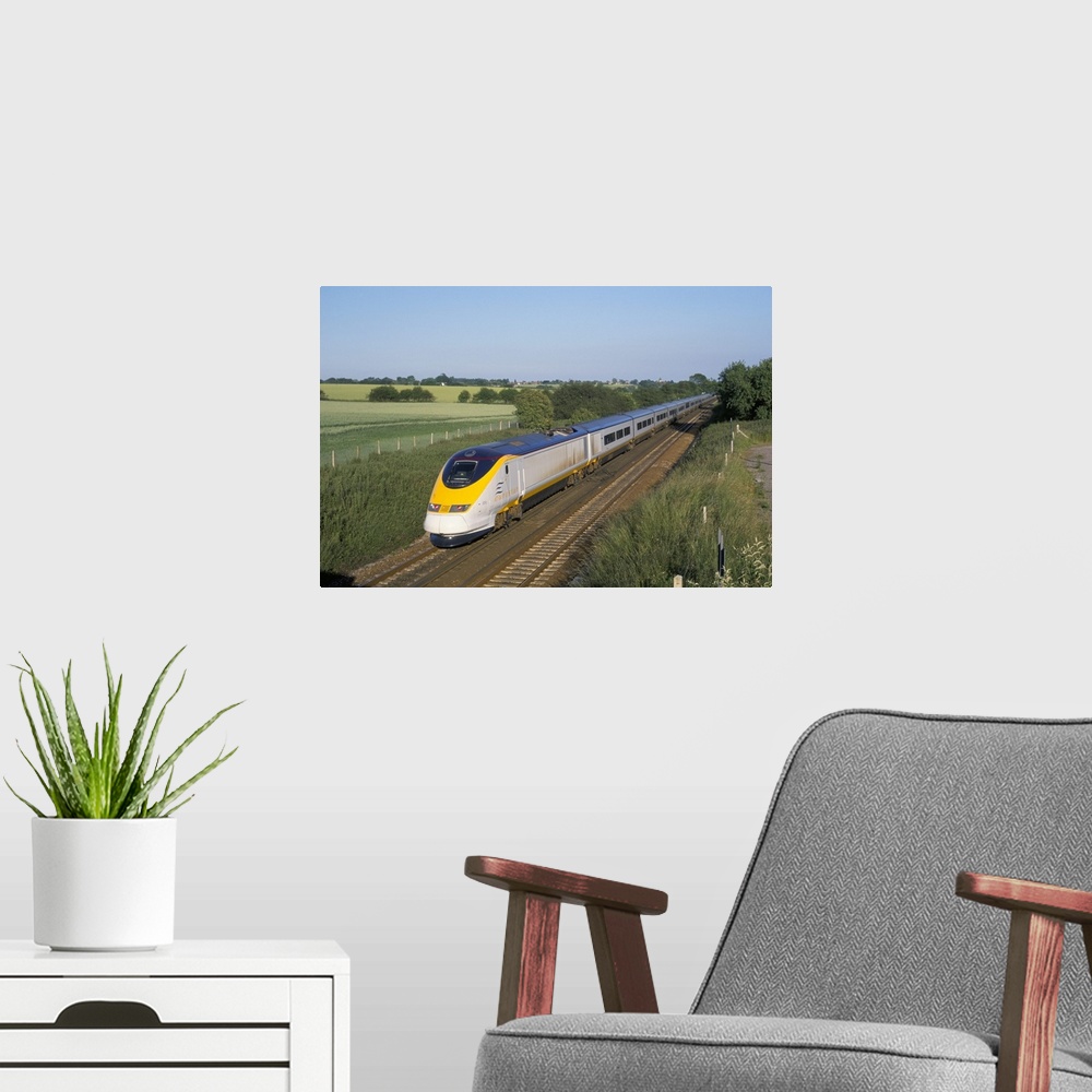 A modern room featuring Eurostar train travelling through countryside